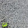An overhead shot of a pile of half-inch gray gravel. A green and black "CRAFTSMAN 25'" tape measure is in the bottom left corner, providing a sense of scale for the size of the rocks. The gravel is light gray and has a rough, angular texture.