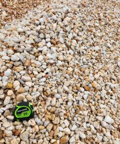 An overhead photo shows a pile of small, rounded pebbles and stones, in a mix of light tans, whites, and light browns. A green and black "CRAFTSMAN 25'" tape measure is in the bottom left corner, providing a sense of scale for the size of the stones.