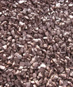 An overhead, close-up photo of a pile of small, reddish-brown crushed stones or gravel. The rocks are irregular and angular in shape, and the sunlight creates a slight sheen on their surfaces.